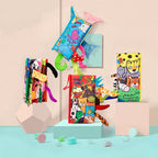 Collection of colorful children's books and toys on a light blue surface with a beige background
